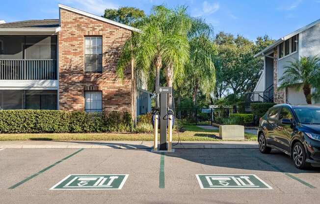 Apartment building exterior and EV charging station at Grand Pavilion Apartments in Tampa, FL