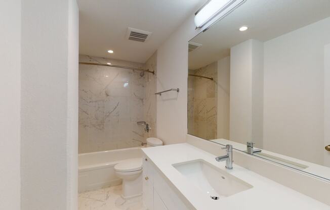 a bathroom with a sink toilet and bathtub