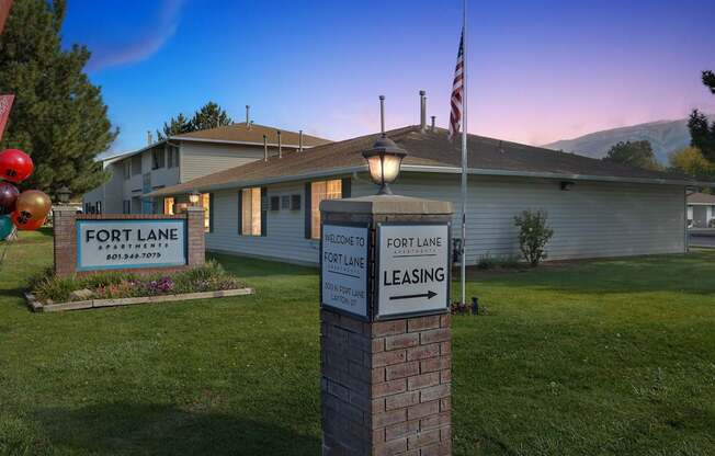 A sign in front of a house that says "Fort Lane Leasing".