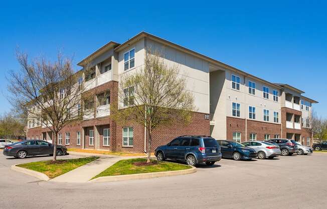 a large apartment building with a parking lot in front of it