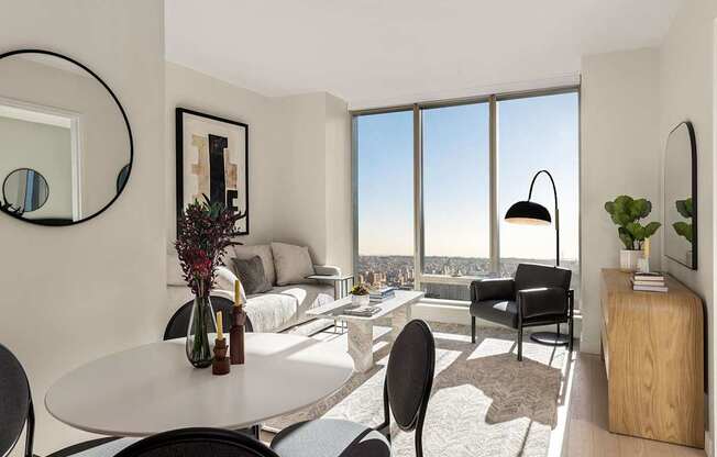 a living room with a view and a table and chairs at The Paxton, Brooklyn, NY