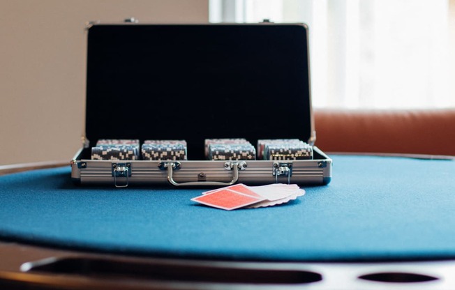 A black case with a handle is on a blue table.