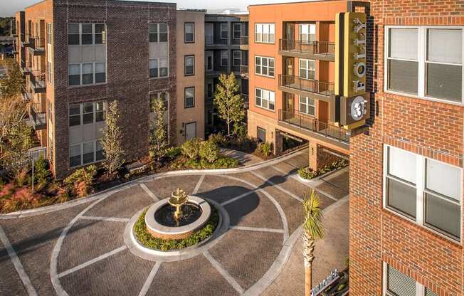 A courtyard with a fountain in the middle of it.