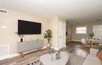 A living room with a white coffee table and a grey cabinet.