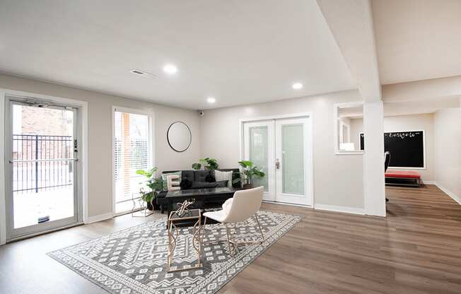 A modern dining room with a black table and chairs.