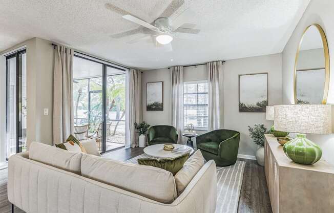 Living room with a couch and a table and a ceiling fan at The Atlantic Preserve, Plantation, FL 33322