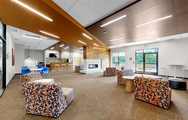 A modern office space with a carpeted floor, a long table with chairs, and a television mounted on the wall.