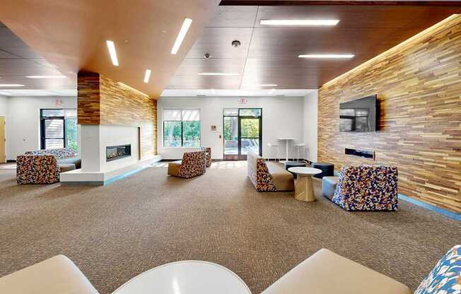 A spacious room with a stone wall and a fireplace.