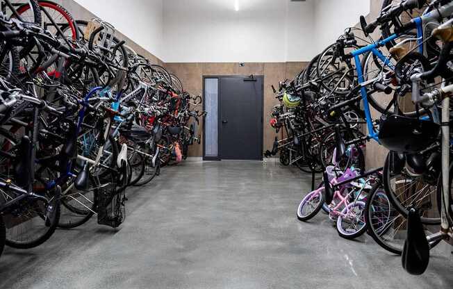 A bike storage room with many bikes on racks.
