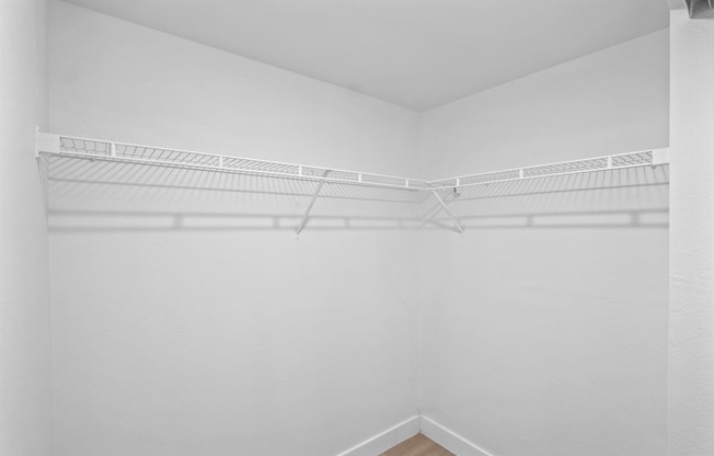 the spacious closet in the living room of an apartment with white walls
