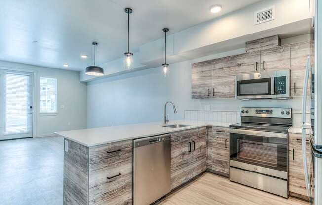 A modern kitchen with wooden cabinets and stainless steel appliances.