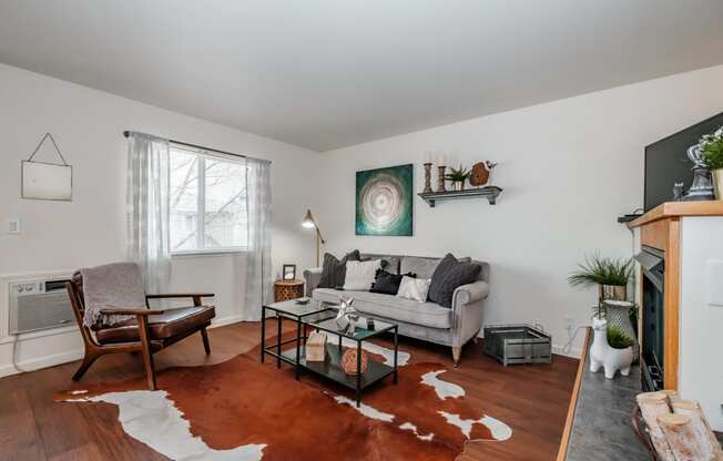 a living room with white walls and hardwood floors