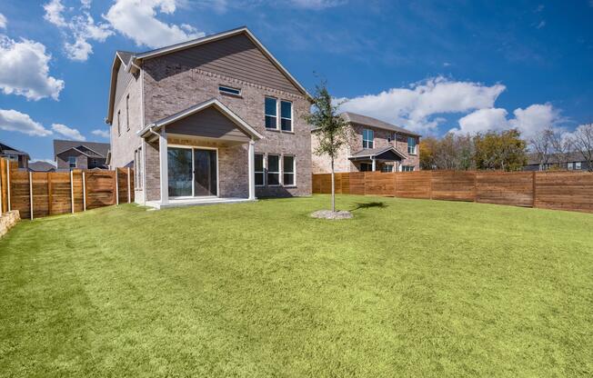 A spacious fenced backyard offers room to relax, play, or gather, extending everyday living into a private outdoor setting behind the home.