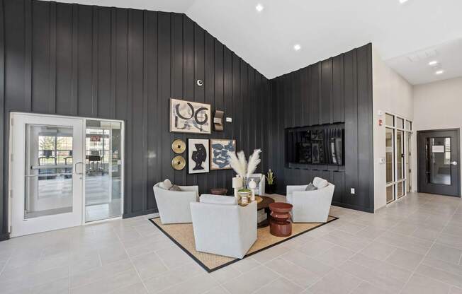 A modern living room with a black wall and a white sofa.