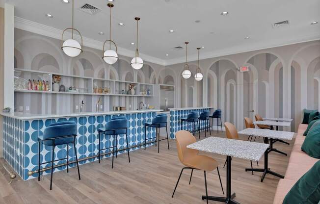 a Clubhouse with blue and white tables and chairs and a bar