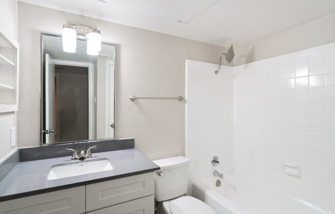 a bathroom with a sink toilet and bathtub