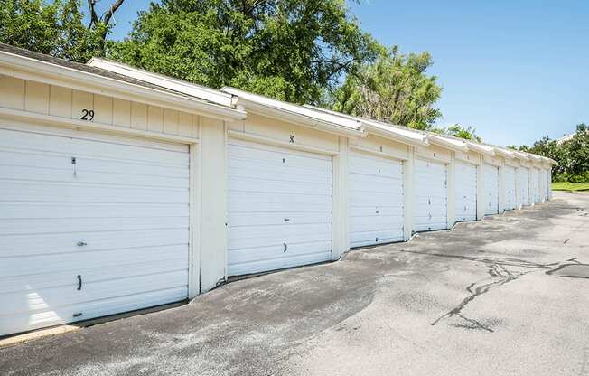 a row of white garages with white doors