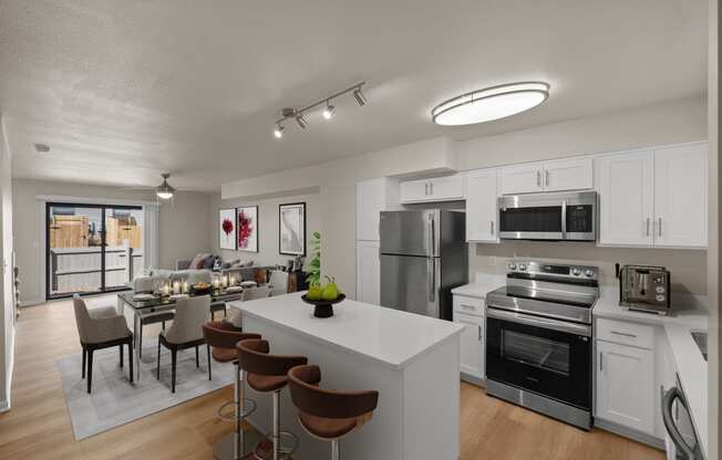 furnished kitchen and dining room with stainless steel appliances and a white island with stools