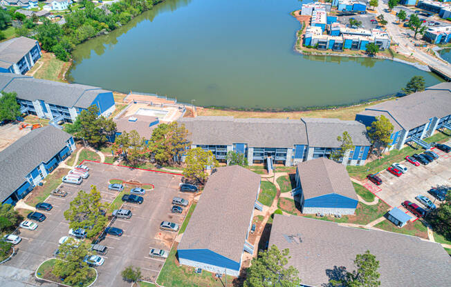 an aerial view of a group of buildings and a lake