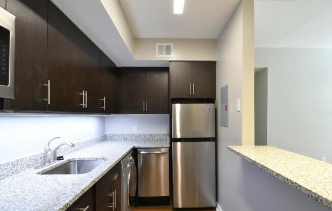 a kitchen with granite countertops and stainless steel appliances