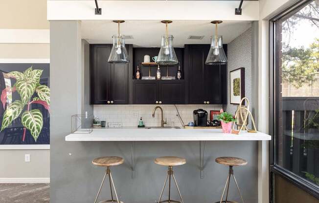 a kitchen with a counter and bar stools