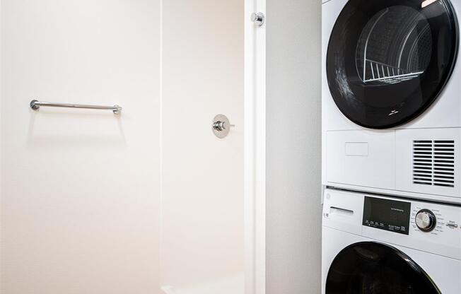 a washer and dryer in a laundry room with a white wall and a