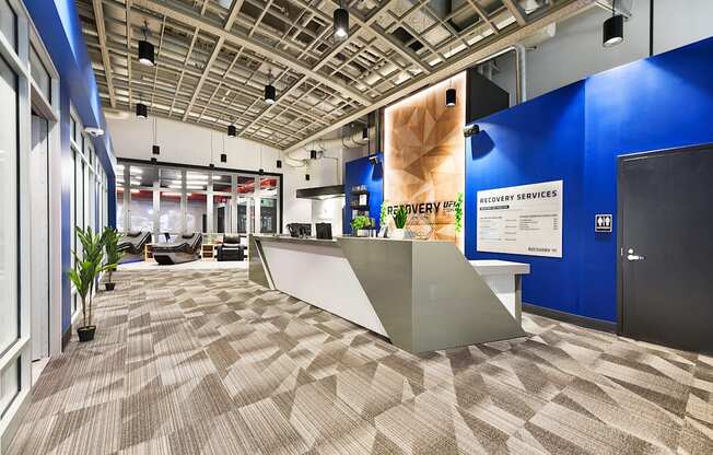 a view of a lobby with a reception desk and blue walls