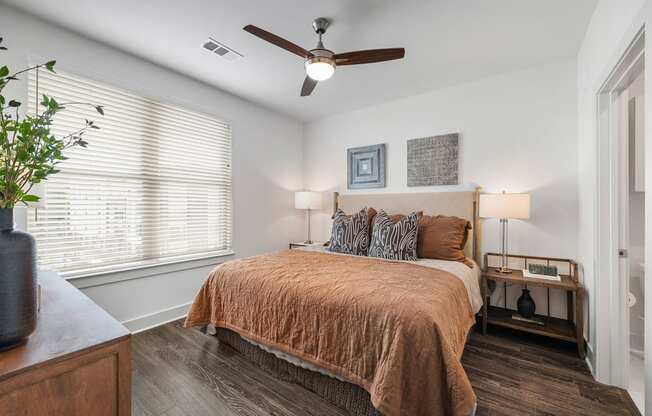 a bedroom with a bed and a ceiling fan