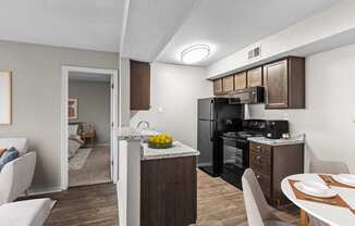 our apartments have a kitchen and dining room with a table and chairs