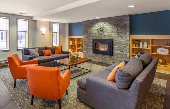 a living room with couches and chairs and a fireplace