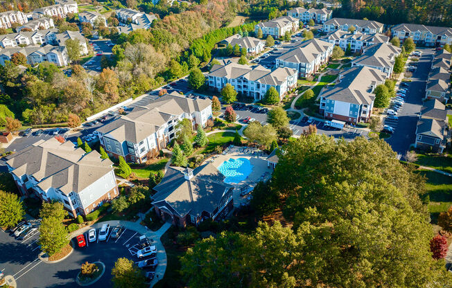 a aerial view of a neighborhood with houses and a swimming pool