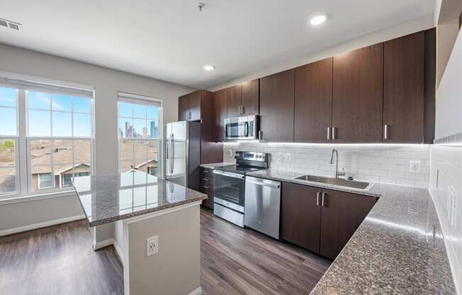 a large kitchen with granite counter tops and stainless steel appliances