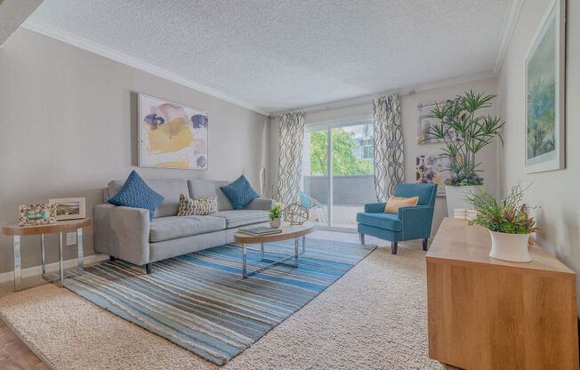 a living room with a couch and a chair at City View Apartments at Warner Center, Woodland Hills