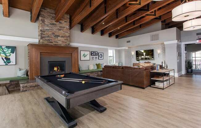 Clubroom with billiards table and fireplace