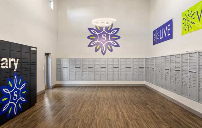 a large room with lockers and a large painting on the wall