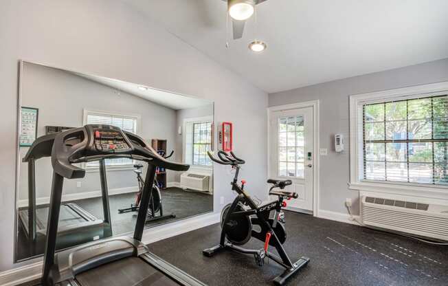 a home gym with a treadmill and exercise bike