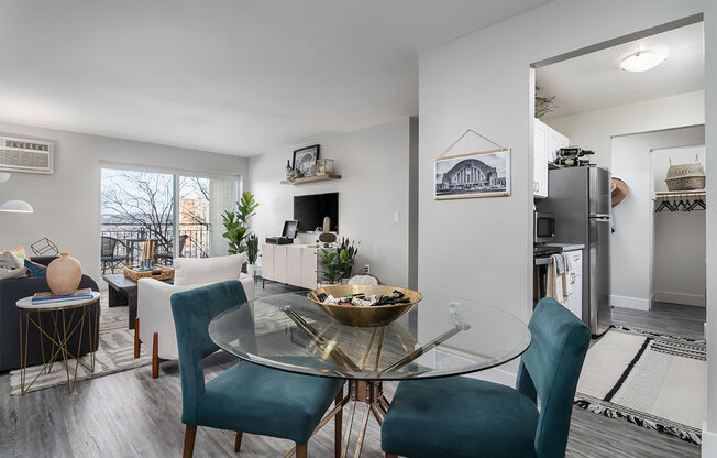 an open living room and dining room with a glass table at The Heights Apartments, Cincinnati, Ohio
