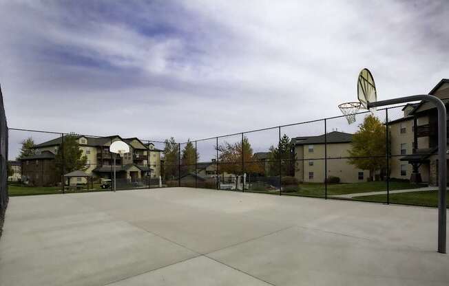 A basketball court with a net and a basketball hoop.