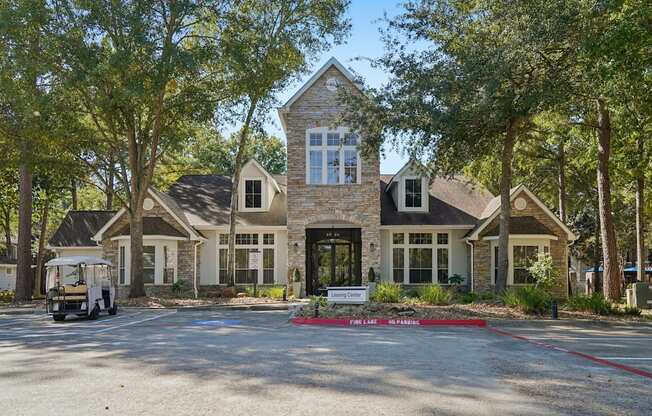 A large house with a stone facade and a sign that says "Fairlane.".