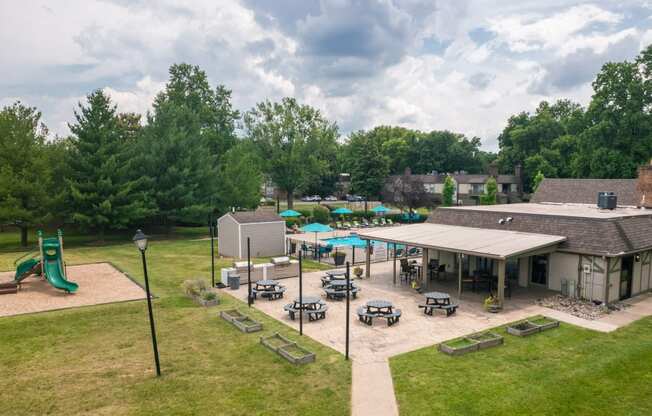 an aerial view of a playground and a pavilion with picnic tables