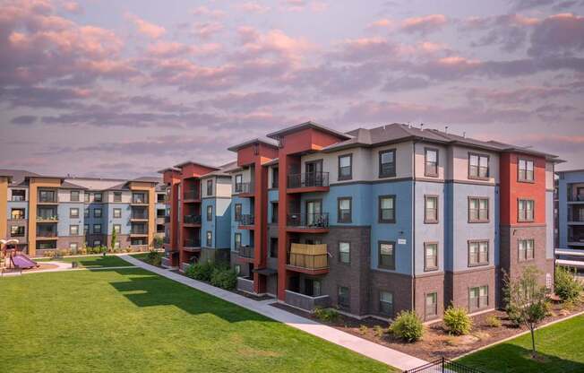 Apartment complex with multiple buildings and green lawns.