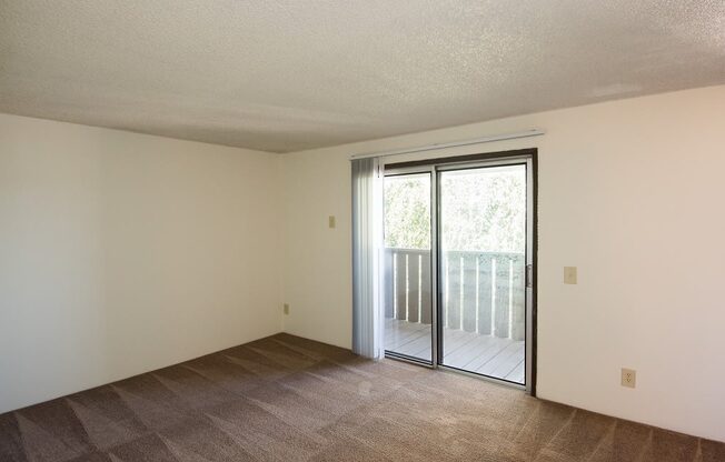 Rolling Hills Vacant Apartment Living Room & Sliding Door to Deck