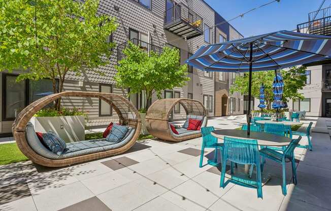 a patio with chairs and tables and umbrellas