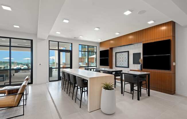 a communal area with a table and chairs in a modern office space