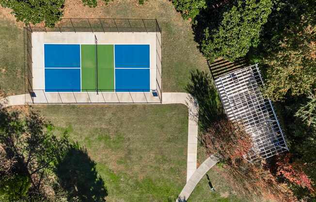 A swimming pool surrounded by trees and a solar panel.