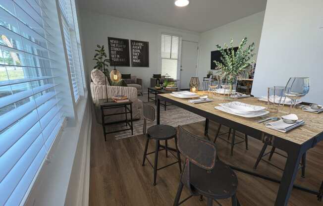 a dining room and living room with a table and chairs at The Courts Midtown, Memphis