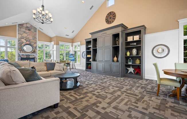 A living room with a stone wall and a large clock on the wall.
