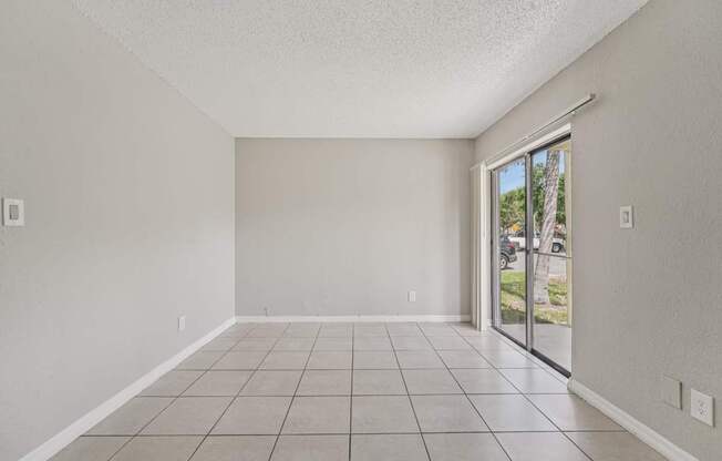 A room with a sliding glass door leading to a patio.