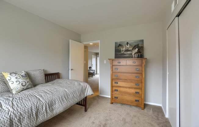 Mechanicsburg Apartments | Delbrook Manor Apartments | a bedroom with a bed and a dresser