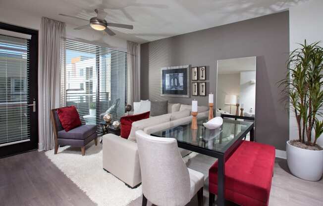 a living room filled with furniture and a large window